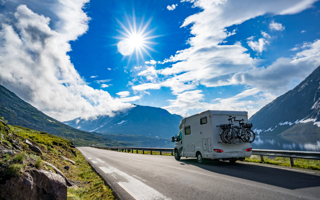 an RV traveling down a beautiful mountain road to demonstrate the benefits of traveling with an RV
